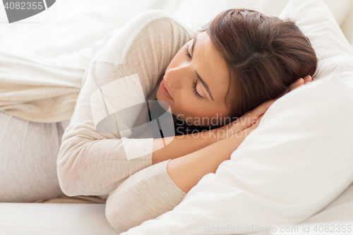 Image of happy pregnant woman sleeping in bed at home