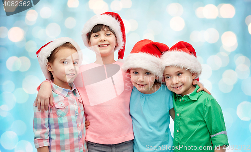 Image of happy little children in christmas santa hats