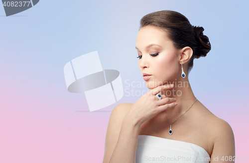 Image of beautiful woman with earring, ring and pendant