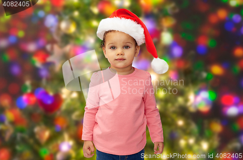 Image of beautiful little baby girl in christmas santa hat