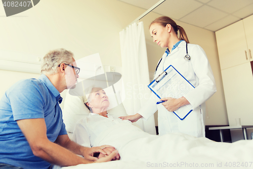 Image of senior woman and doctor with clipboard at hospital