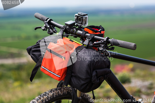 Image of Bicycle with orange bags for travel