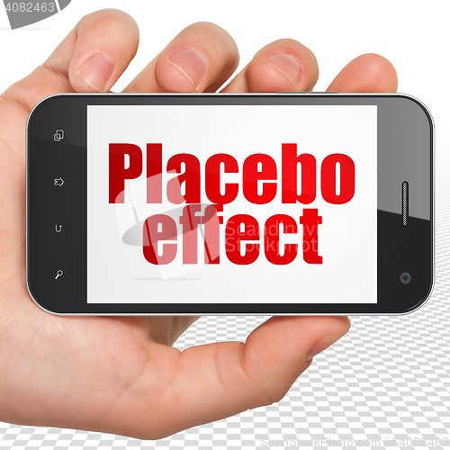 Image of Health concept: Hand Holding Smartphone with Placebo Effect on display