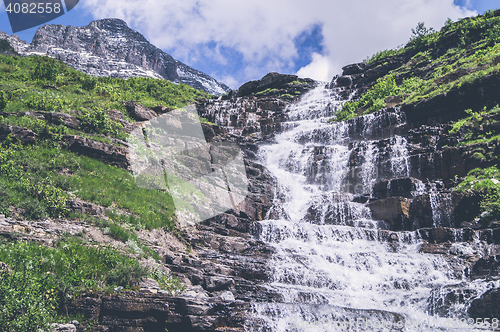 Image of Mountain waterfall with rough cliffs