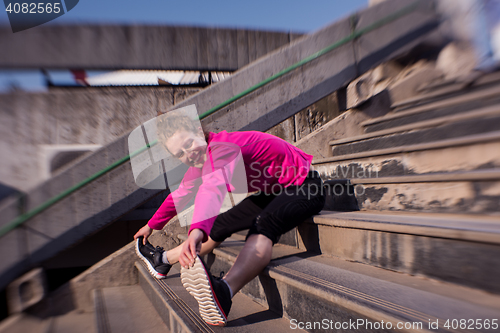 Image of woman  stretching before morning jogging