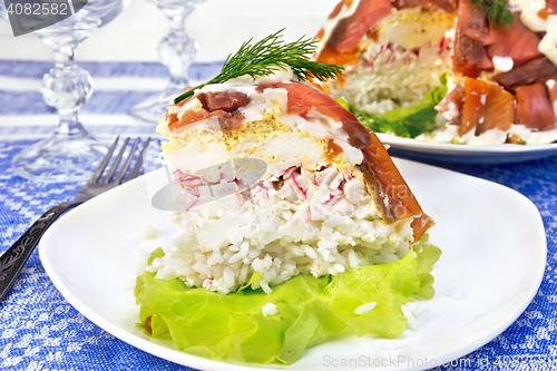 Image of Salad with salmon and rice in plate on tablecloth