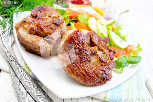 Image of Turkey steak roasted with vegetables on light board