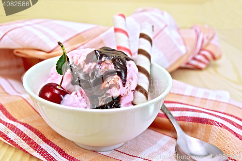 Image of Ice cream cherry with wafer rolls on board