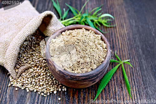 Image of Flour hemp in clay bowl with grain on board