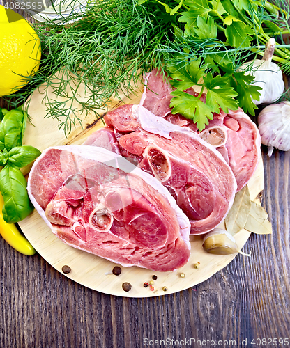 Image of Turkey steak raw with spices on board