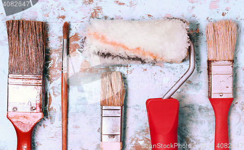 Image of Set Of Paint Brushes On A Light Wooden Background