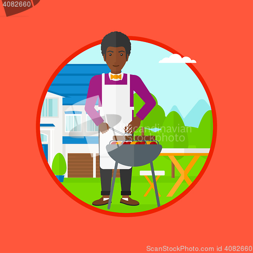 Image of Man cooking meat on barbecue grill.