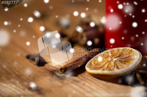 Image of cinnamon, anise and dried orange on wooden board