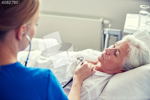 Image of nurse with stethoscope and senior woman at clinic