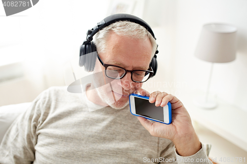 Image of happy senior man with smartphone and headphones