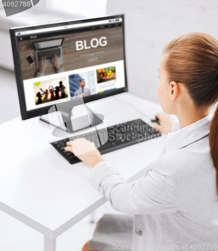 Image of businesswoman with computer blogging at office