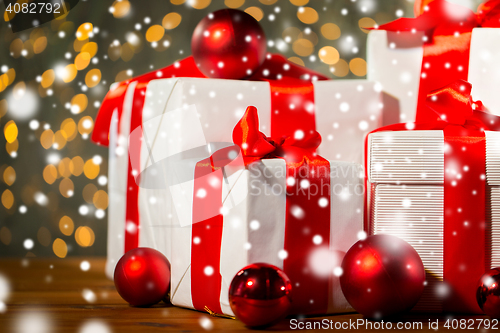 Image of gift boxes and red balls on wooden floor