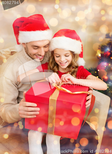 Image of smiling father and daughter opening gift box