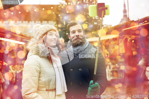 Image of couple taking selfie with smartphone in old town