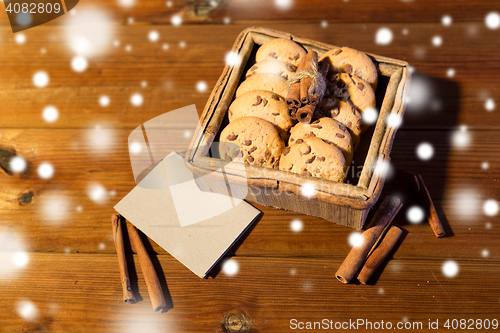Image of close up of oat cookies and card  on wooden table