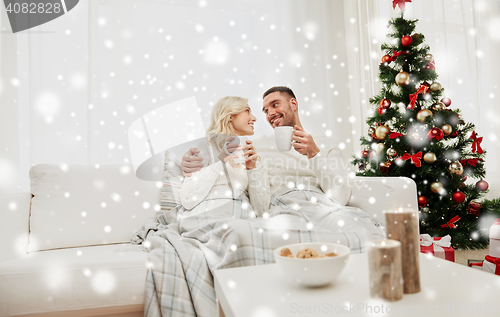 Image of happy couple at home with christmas tree