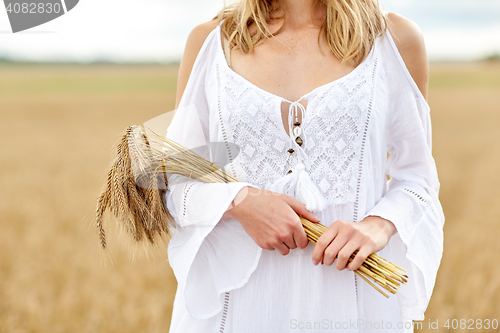 Image of close up of happy woman with cereal spikelets