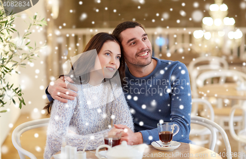 Image of happy couple drinking tea at restaurant