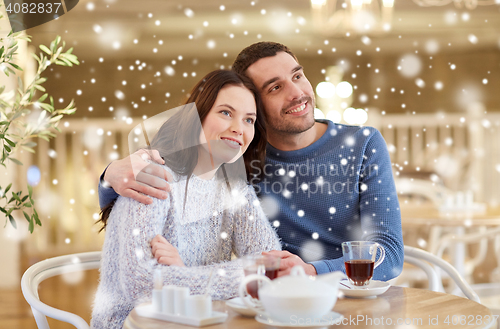 Image of happy couple drinking tea at restaurant