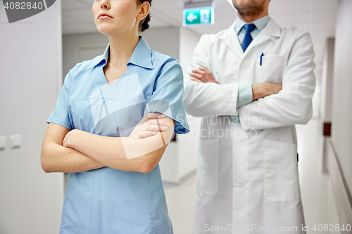 Image of close up of doctor and nurse at hospital corridor