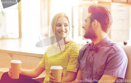 Image of happy man and woman drinking coffee in office