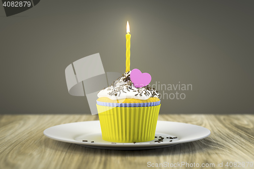 Image of delicious cupcake with a burning candle