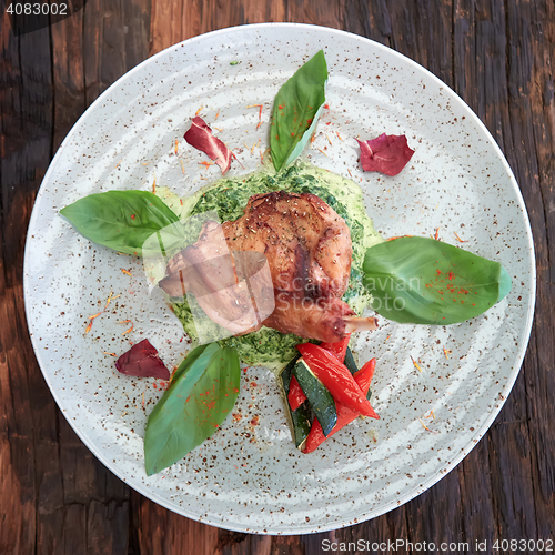 Image of cooked rabbit meat with spinach and raisins