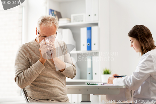 Image of senior man and doctor meeting at hospital