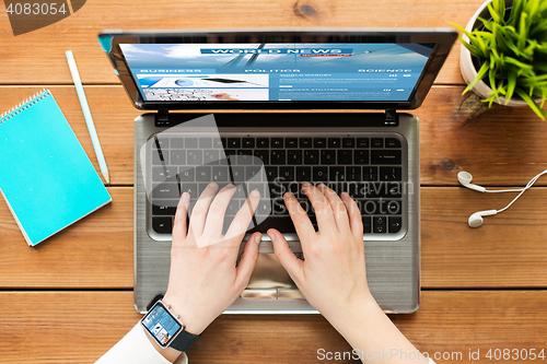 Image of close up of woman with world news on laptop