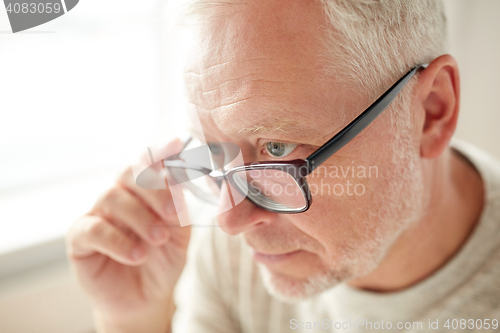 Image of close up of senior man in glasses looking