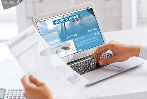 Image of businessman with laptop computer working at office