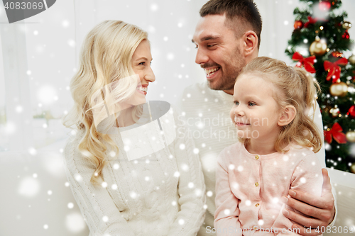 Image of happy family at home with christmas tree