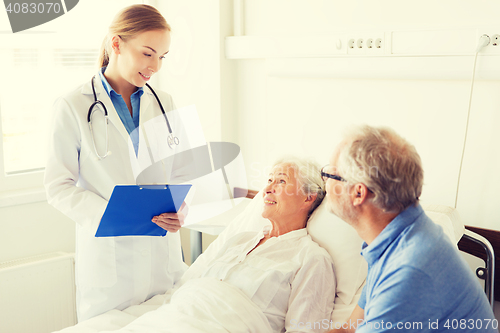 Image of senior woman and doctor with clipboard at hospital