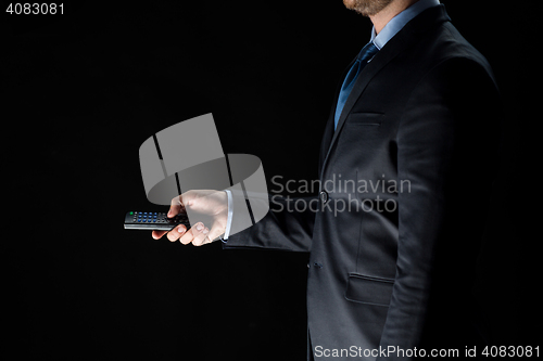 Image of close up of businessman with remote controller