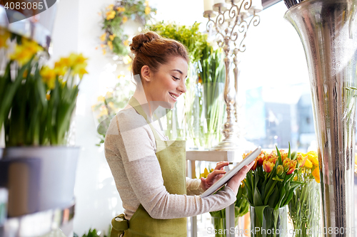 Image of woman with tablet pc computer at flower shop