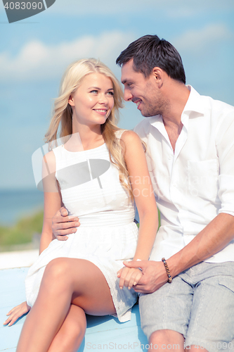 Image of smiling couple at sea side