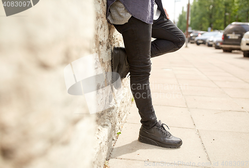 Image of close up of man standing at street wall