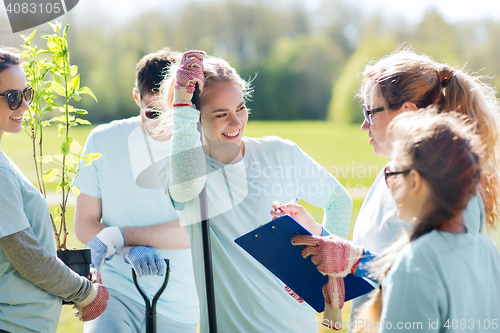 Image of group of volunteers planting trees in park