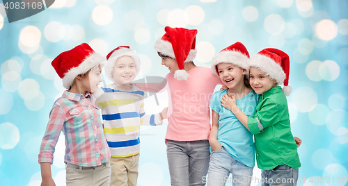 Image of happy little children in christmas santa hats