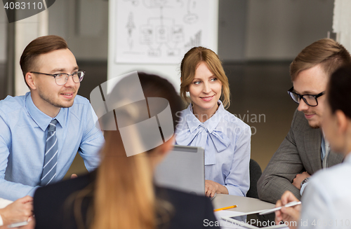Image of smiling business people meeting in office