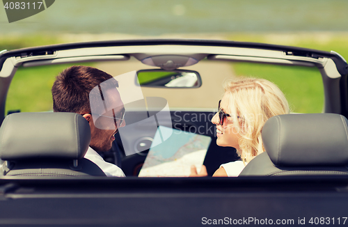 Image of happy man and woman driving in cabriolet car