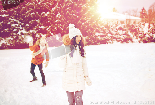 Image of happy couple playing snowballs in winter