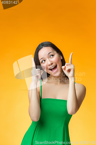 Image of The happy Chinese girl on yellow background