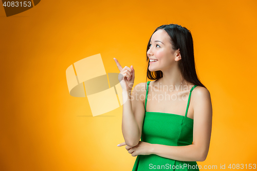 Image of The happy Chinese girl on yellow background