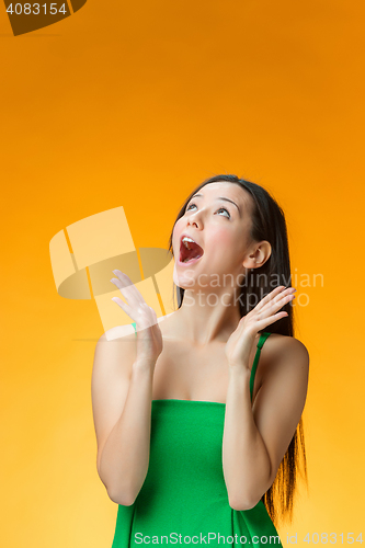 Image of The happy Chinese girl on yellow background